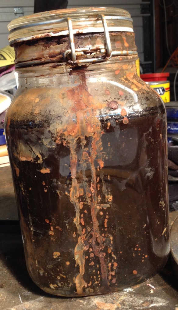 Creating the stain was an interesting process: fill a sealable glass jar with steel wool and apple cider vinegar, shut the top, and leave it there for at least four or five days, or more (10 days for this table). The steel wool slowly dissolves and blackens the mix. And each day I gently shook the jar to mix it up, resulting in a blackish-gray liquid with little specks of swirling steel (it takes weeks for the steel wool to completely disappear).